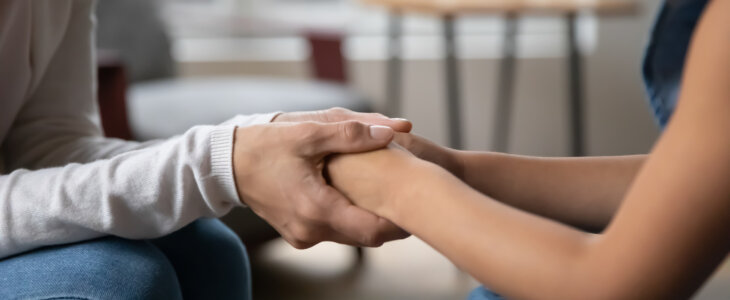 Close up of young mom hold little daughter hands talk share secrets make peace at home, mother and small daughter enjoy tender close moment family moment, show love care and gratitude in relationships