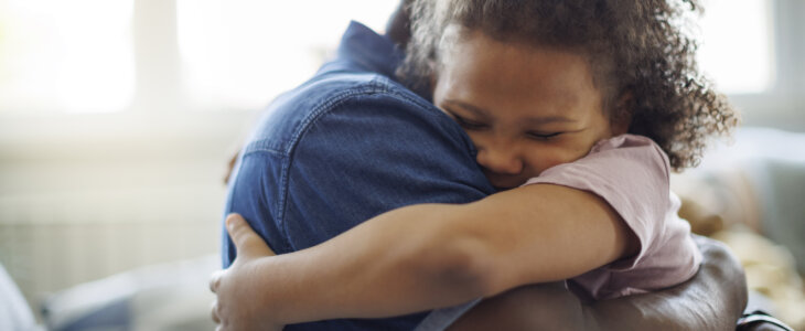 Guardian and child hugging